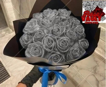 A bouquet of artificial roses covered in glitter is displayed in a black box with a blue ribbon.