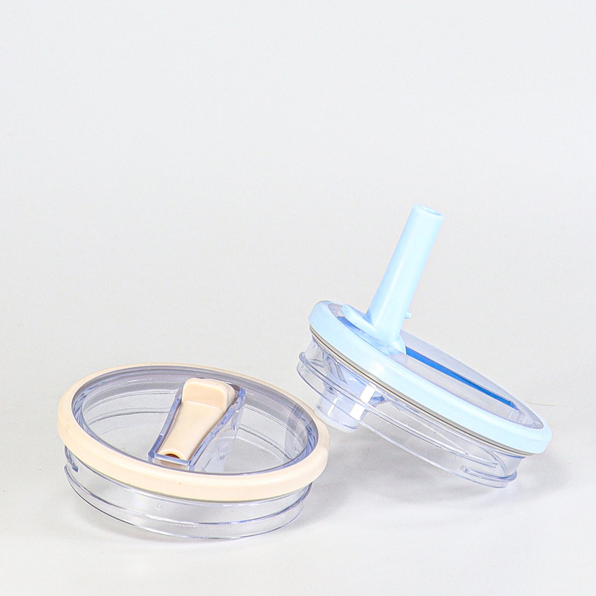 A clear blue replacement lid for a tumbler, shown next to the cup it fits onto.