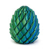 A teal green dragon egg stress relief toy with a textured, scale-like surface.