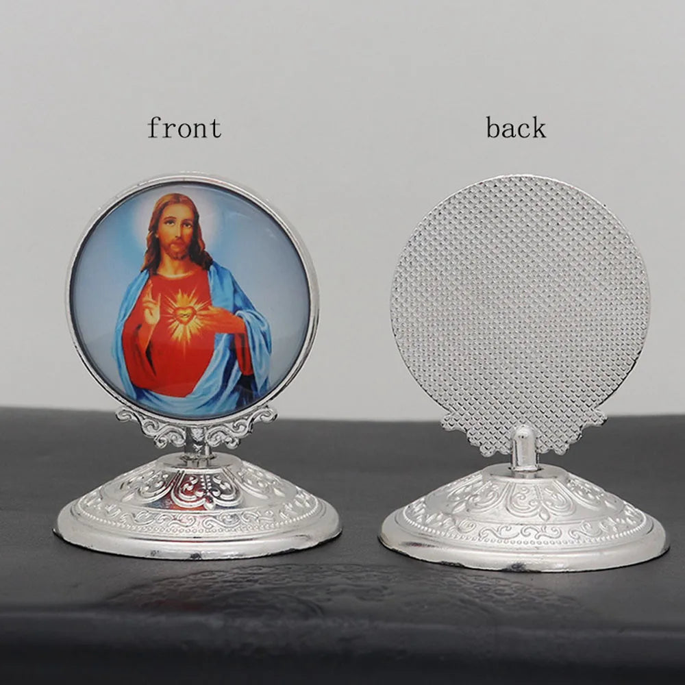 A pair of silver-toned tabletop ornaments featuring a front image of Jesus and a back textured disc.