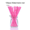 A glass jar filled with 100 pink watermelon red paper lollipop sticks.