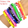 A collection of silicone bracelets featuring the name Jesus with a heart design in various colors