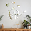 Decorative wall stickers featuring three-dimensional acrylic hearts with a mirror finish on a white wall.
