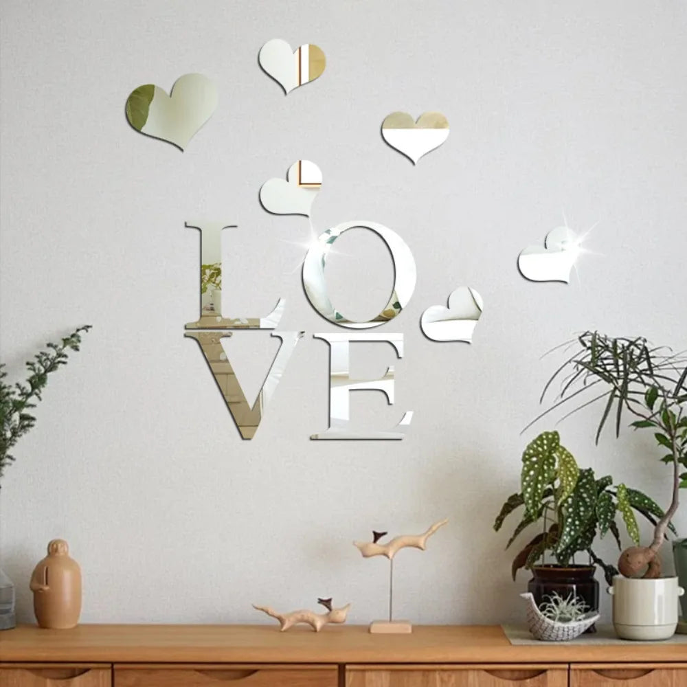 Decorative wall stickers featuring three-dimensional acrylic hearts with a mirror finish on a white wall.