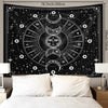 Black tapestry wall hanging featuring a psychedelic sun and moon mandala design with stars