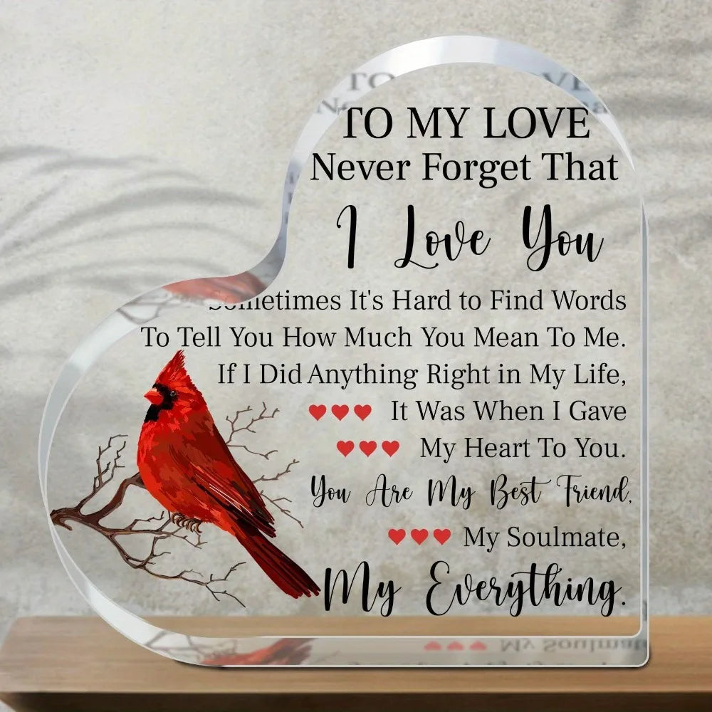 Heart-shaped acrylic plaque with a red bird design and a message to love