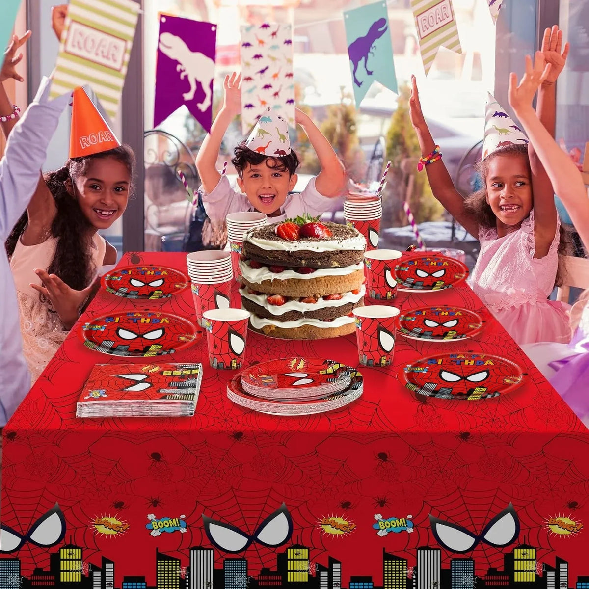 A red table decorated with Spider-Man themes featuring a cake, plates, and party decorations.