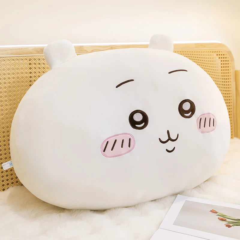 A white Usagi Chiikawa plush doll with pink accents resting on a light-colored surface.