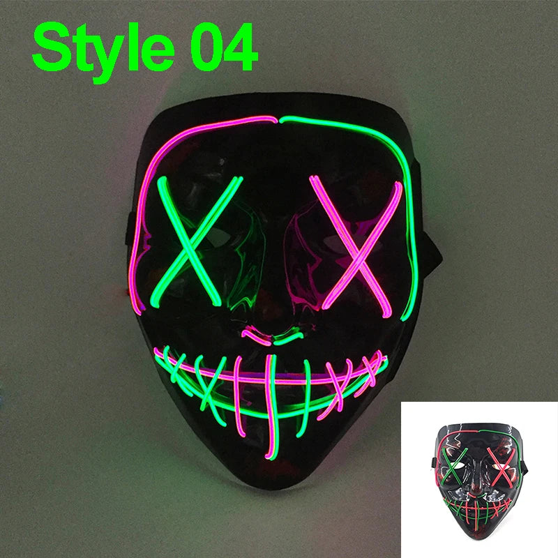 A black glow-in-the-dark LED purge mask with neon green and pink glowing cross eyes and a grinning mouth.