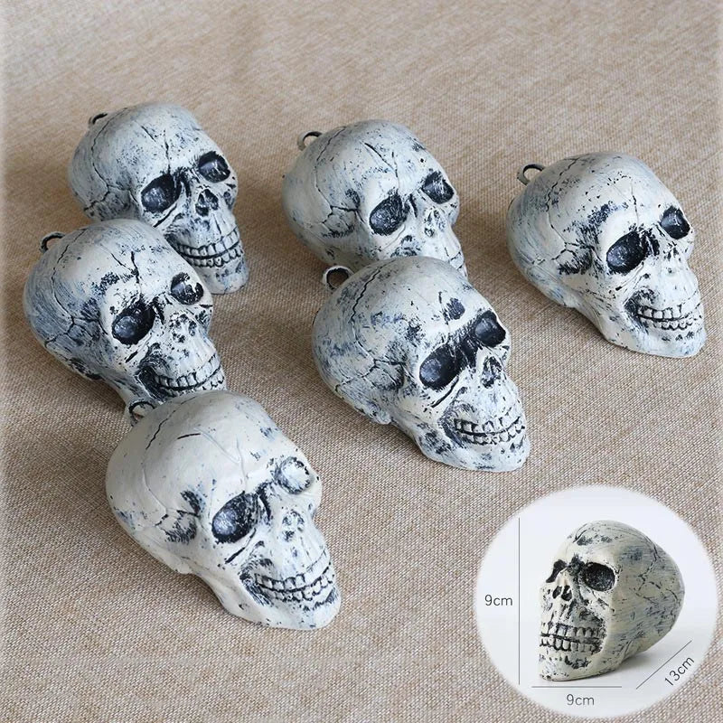 A collection of realistic white skeleton arm stakes for Halloween lawn decor displayed on a beige fabric.