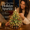 A woman is decorating a sparkling holiday tree with beads indoors.