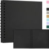 A black spiral-bound notebook or journal with a black cover shown next to a lighter colored palette.