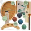 A set of wooden sensory tools including a bamboo tray, sand bottle, sand tools, and sphere holders for relaxation.