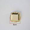 A gold-colored square mini tray with an ornate, scalloped edge.