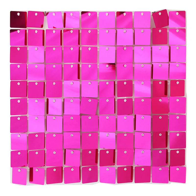 A grid of square iridescent pink sequins used as a shimmering wall backdrop for celebrations.