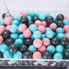 A large quantity of colorful, glossy plastic balls in pink, blue, and gray are displayed in a white wire basket.