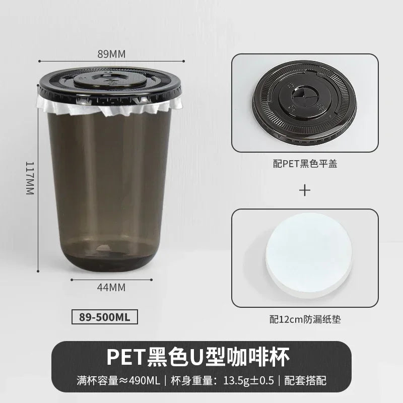 A black disposable U-shaped coffee cup with a lid and a white disc shown in various views.