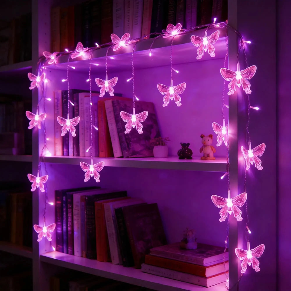 LED butterfly curtain lights strung across a shelf with books and decorative items.
