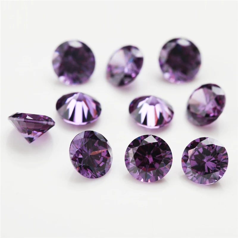 A collection of round cut purple cubic zirconia loose stones of various sizes for jewelry making.