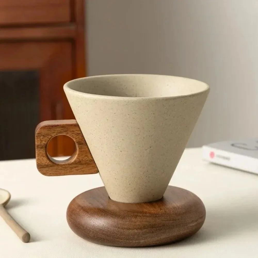 A beige ceramic coffee mug rests on a round wooden base.
