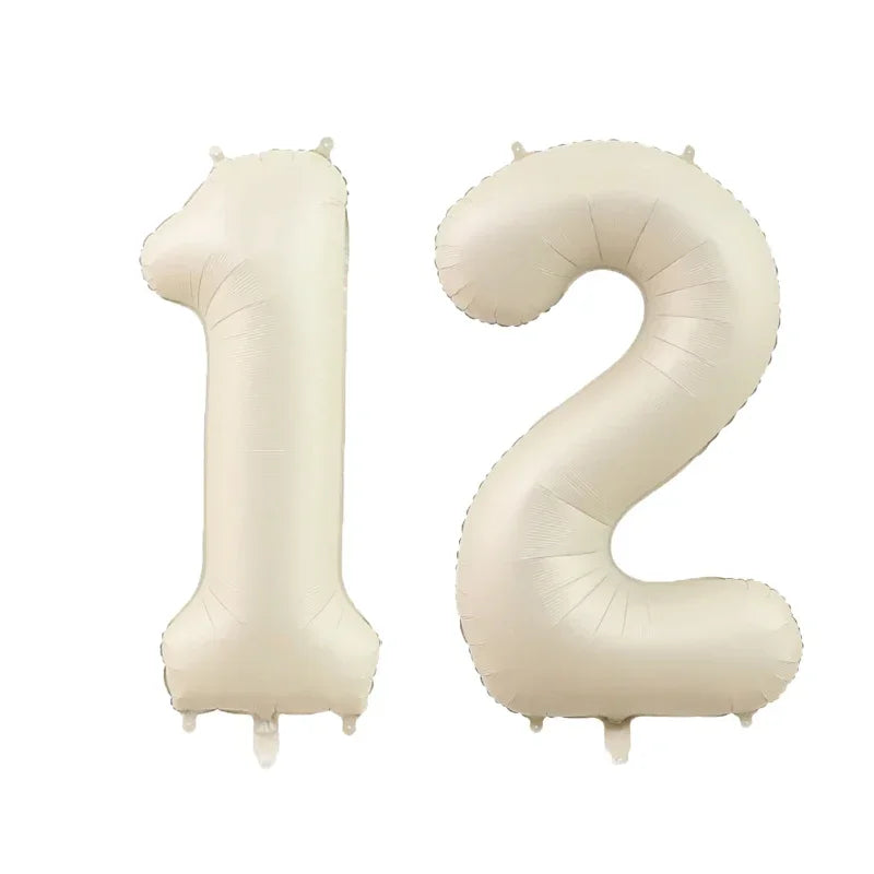Two beige helium foil number balloons shaped like 1 and 2