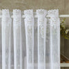 White lace mesh sheer curtain with rod pocket hanging on a white rod.