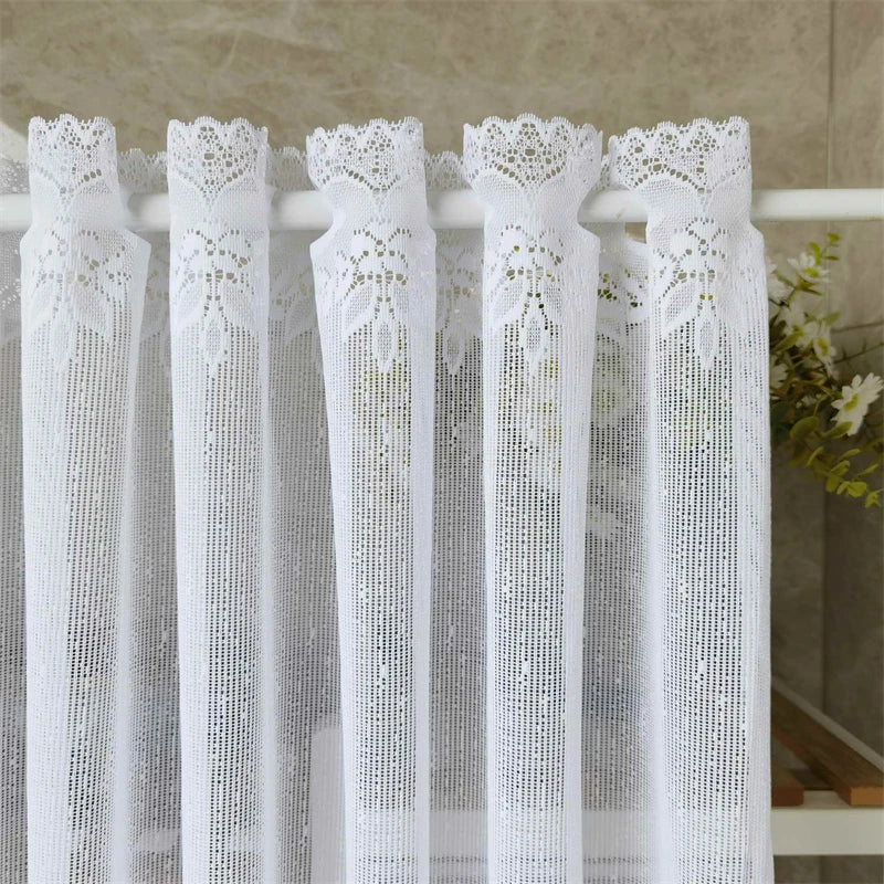 White lace mesh sheer curtain with rod pocket hanging on a white rod.