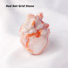 A natural crystal heart carving decoration made of red net grid stone with white and orange veining.