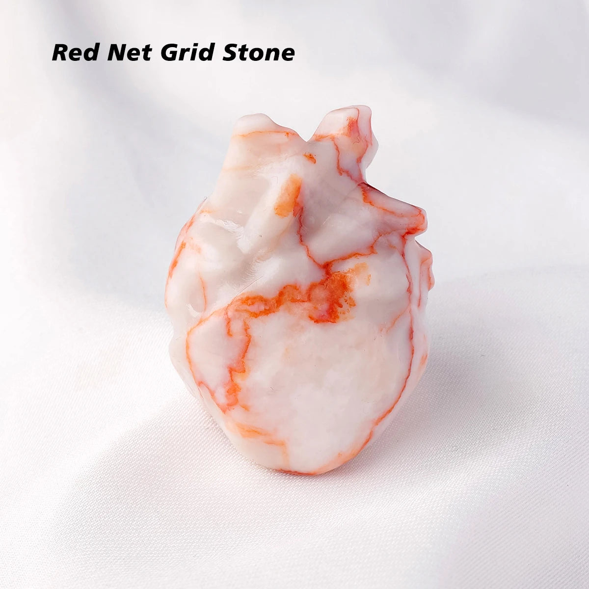 A natural crystal heart carving decoration made of red net grid stone with white and orange veining.
