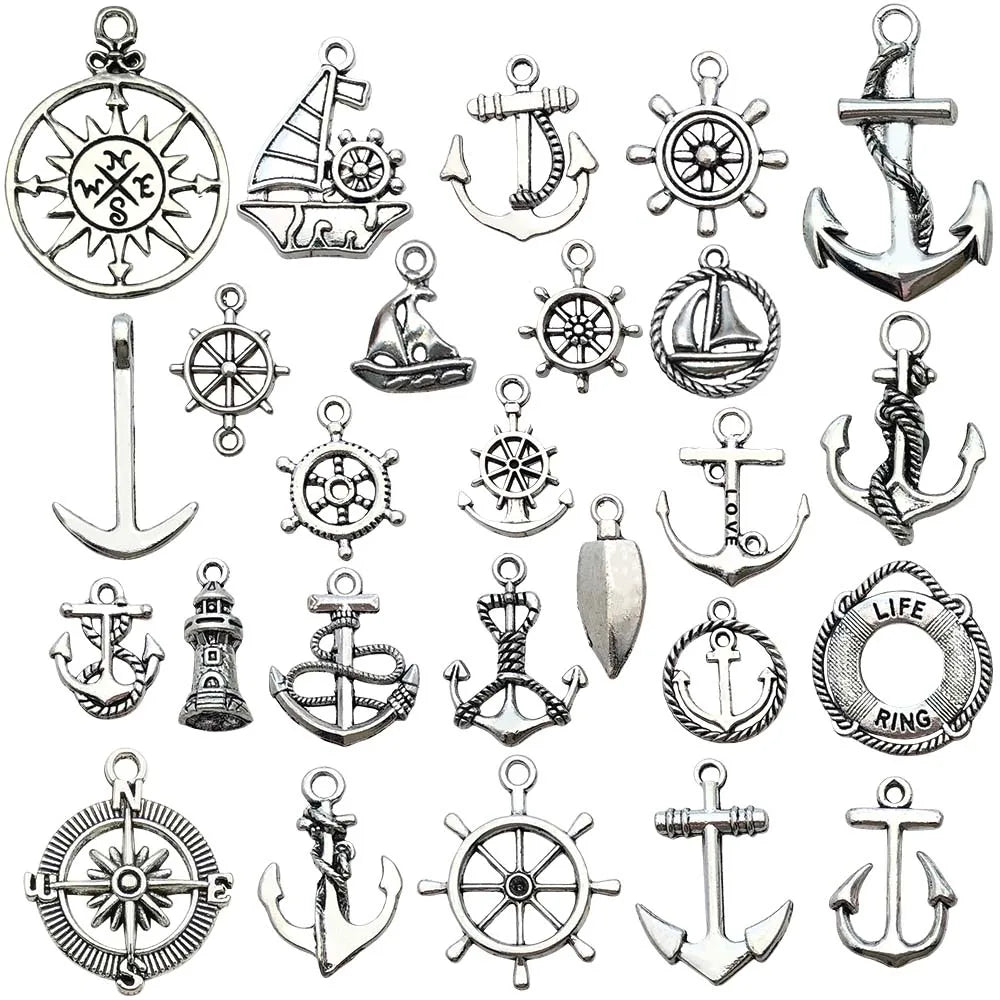 A collection of vintage ship anchor charms and emblems for jewelry making