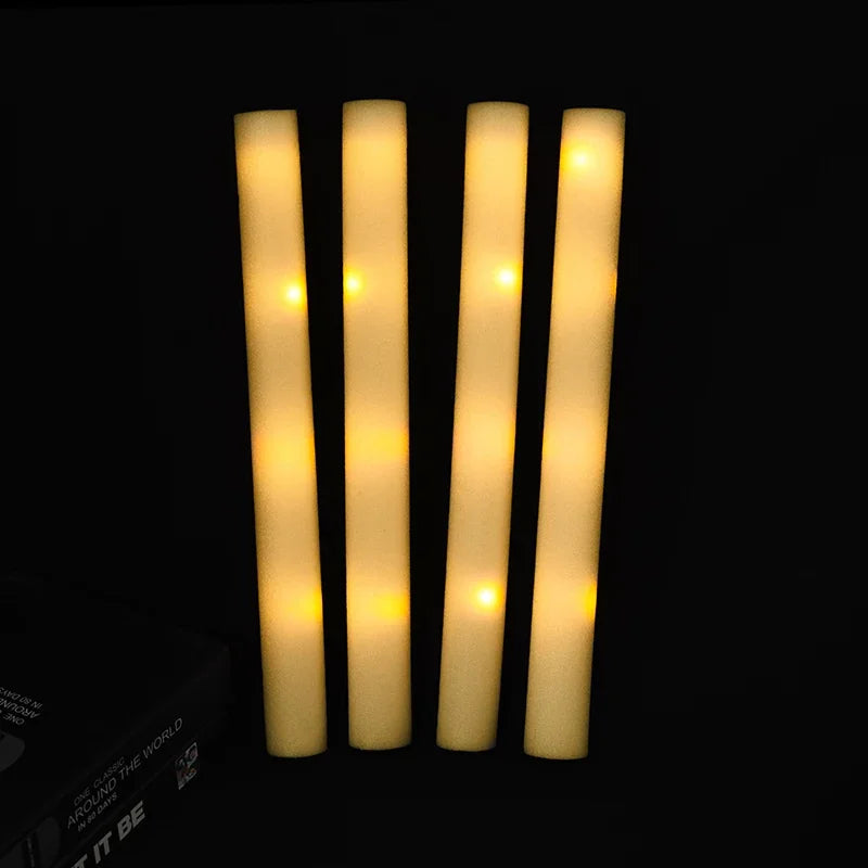Five vertical glow foam sticks emitting a warm yellow light against a dark background.
