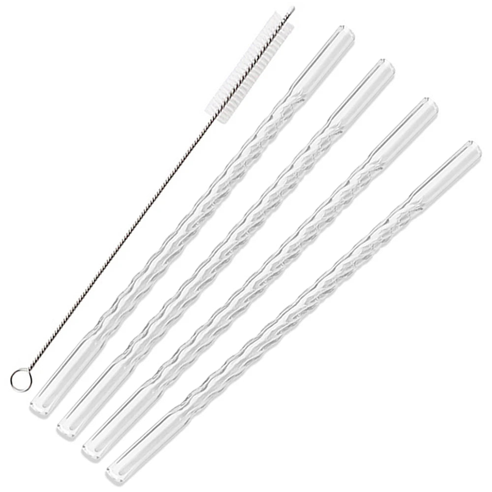 A set of clear borosilicate glass straws with a cleaning brush.