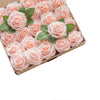 A box filled with pink foam rose artificial flowers with green leaves for weddings and home decor