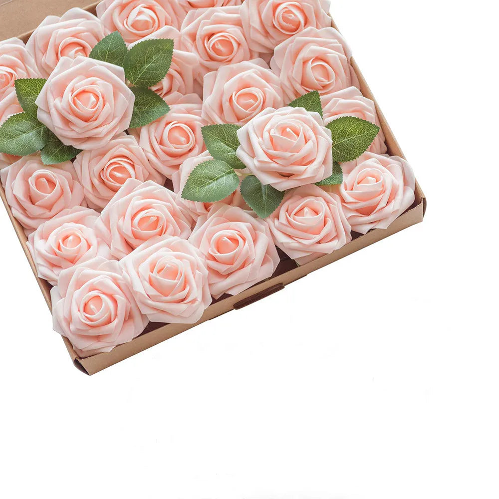 A box filled with pink foam rose artificial flowers with green leaves for weddings and home decor