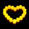 A heart shape formed by multiple yellow flameless LED flickering candles.