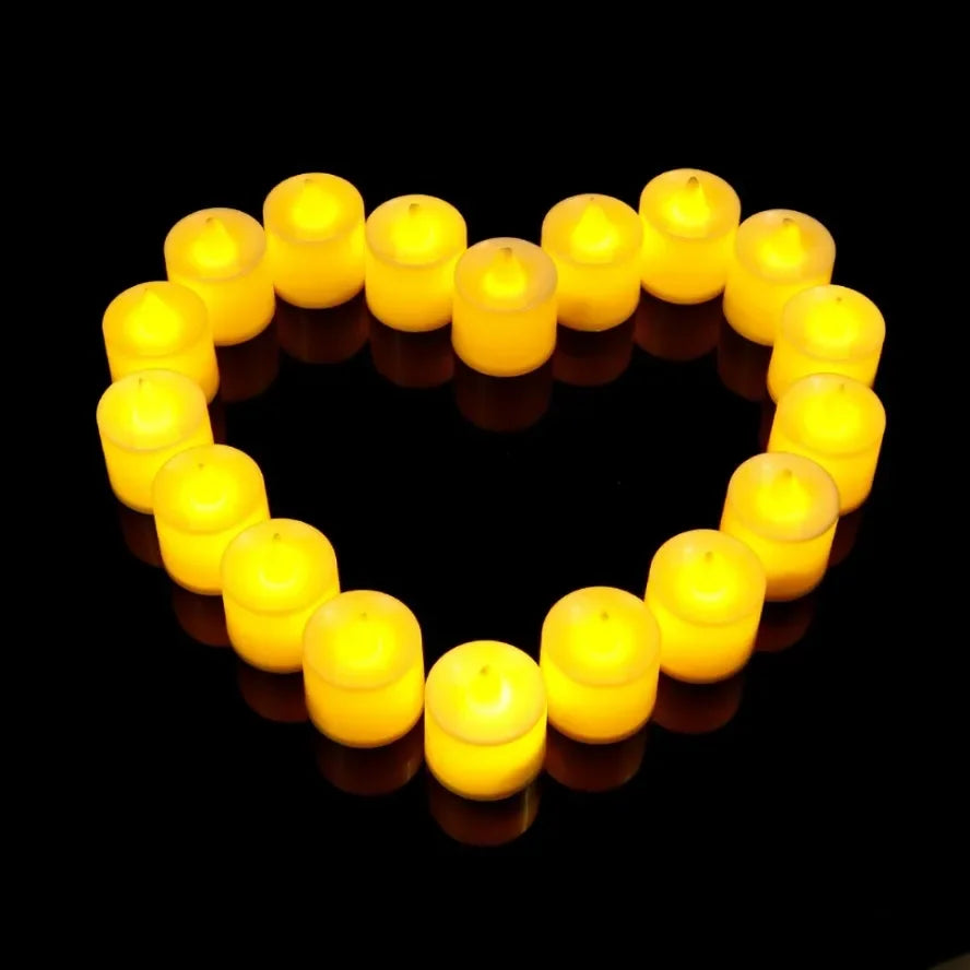 A heart shape formed by multiple yellow flameless LED flickering candles.