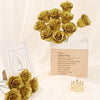 A bouquet of twelve golden glitter artificial roses displayed in a kraft paper bag.