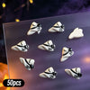 A variety pack of 50 Halloween themed resin nail charms featuring black and white skulls and bats on a clear surface.