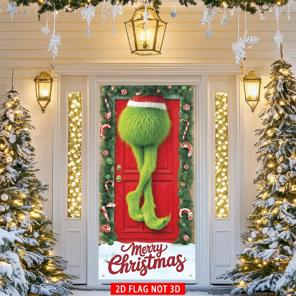 A festive Christmas door cover flag featuring a green elf figure on a red door surrounded by greenery and lights.