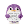 A hand-woven purple penguin plush toy with a white card that reads Positive penguin I may be a tiny penguin but I believe in 