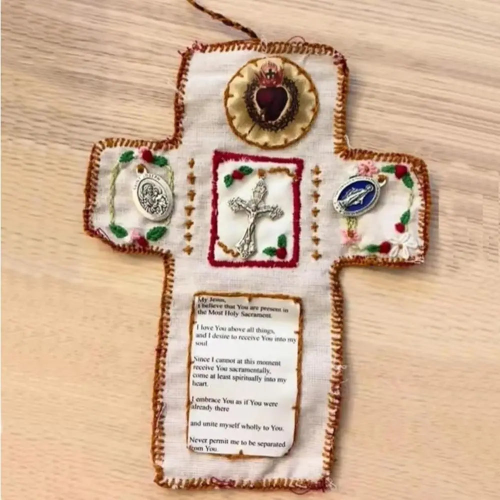Handmade prayer quilt featuring a cross with decorative fabric elements and a silver cross pocket shrine.