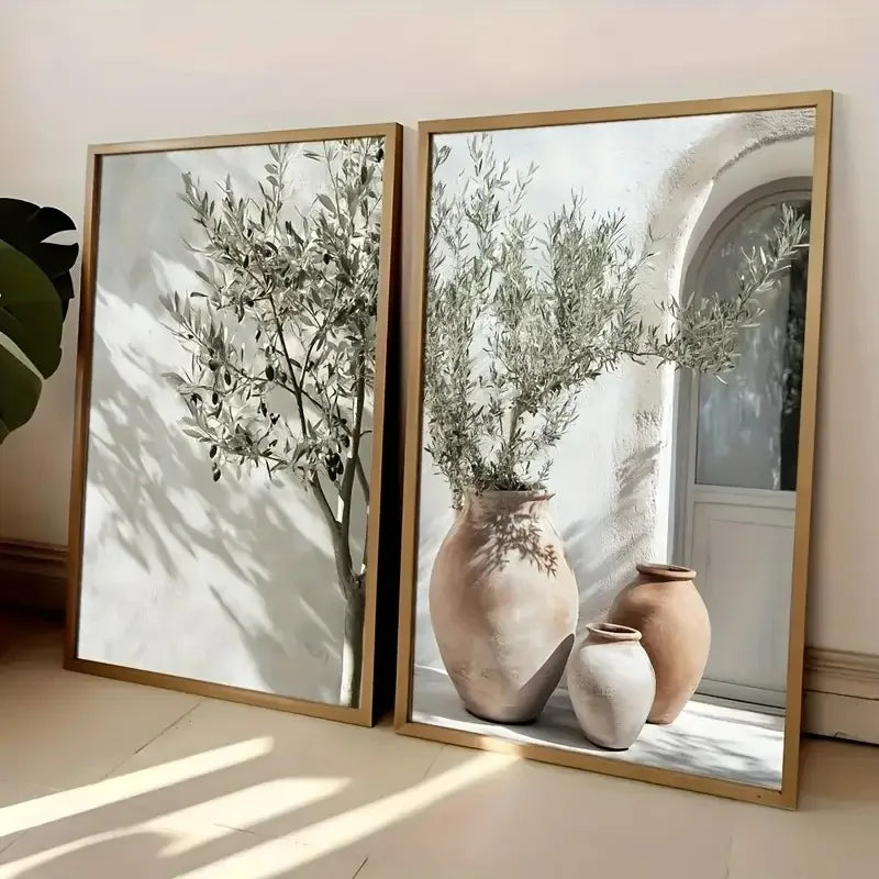 Framed canvas wall art featuring a sprig of olive branches in an earthen vase.