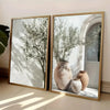 Framed canvas wall art featuring a sprig of olive branches in a terracotta vase.
