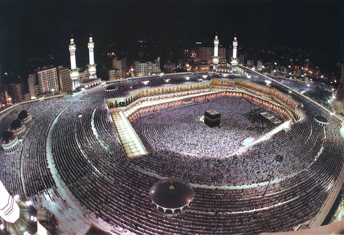 Aerial view of a large crowd gathered in a stadium-like area, likely for a religious event.