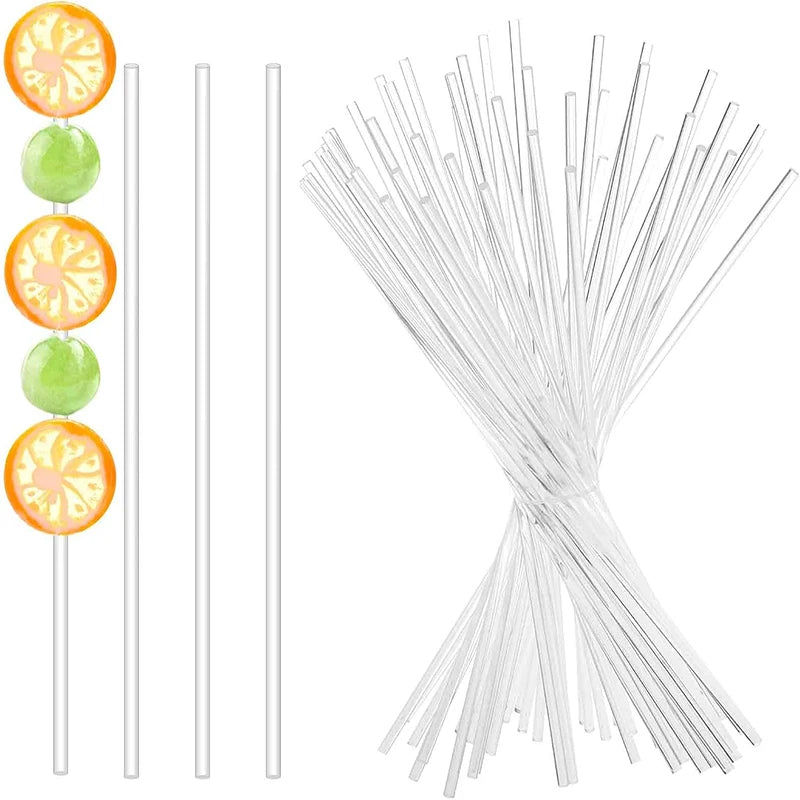 A collection of clear acrylic cake pop sticks in various lengths, including 10, 15, and 20 cm.