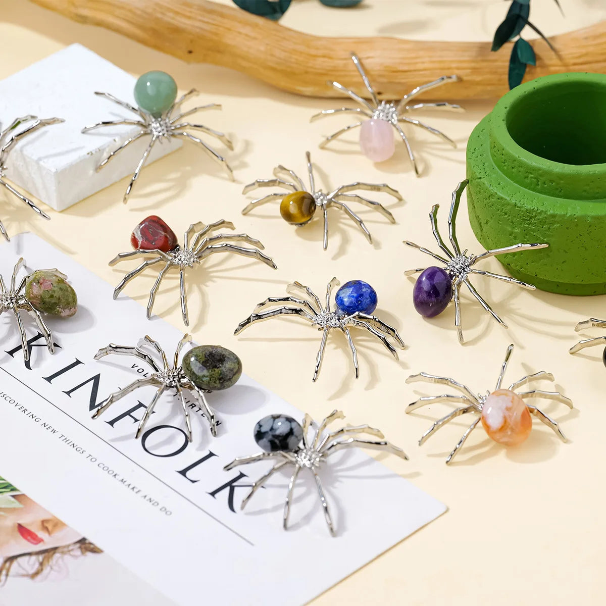 Handcrafted crystal spider figurines with various colors and textures displayed on a light background.
