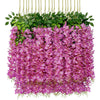 A dense arrangement of artificial purple wisteria flowers and green leaves hanging in a display.