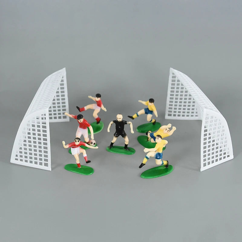 Football birthday cake toppers featuring soccer players and field decor on a gray background.