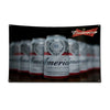 A display of Budweiser beer cans and a red flag featuring the Budweiser logo.