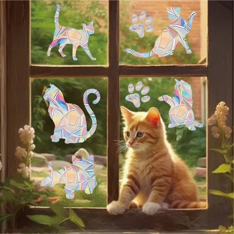 Rainbow suncatcher window stickers featuring cats and butterflies on a window pane.